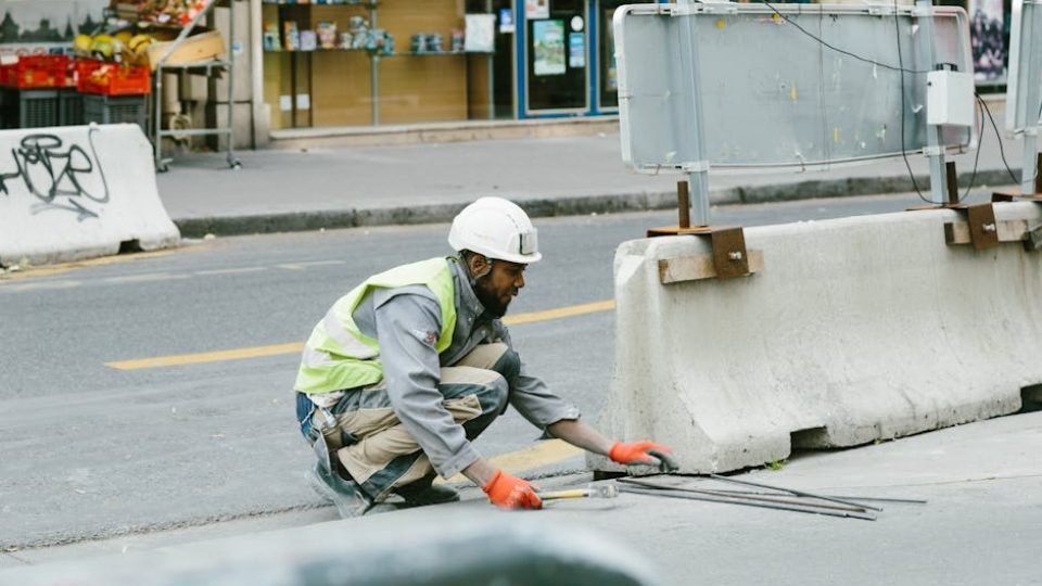 A construction worker operates on a city street in Paris, France, showcasing urban development.